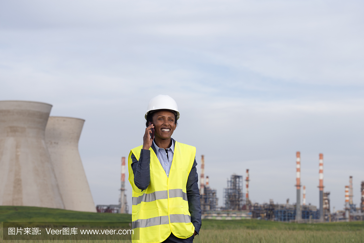 在化工廠打電話的女商人。